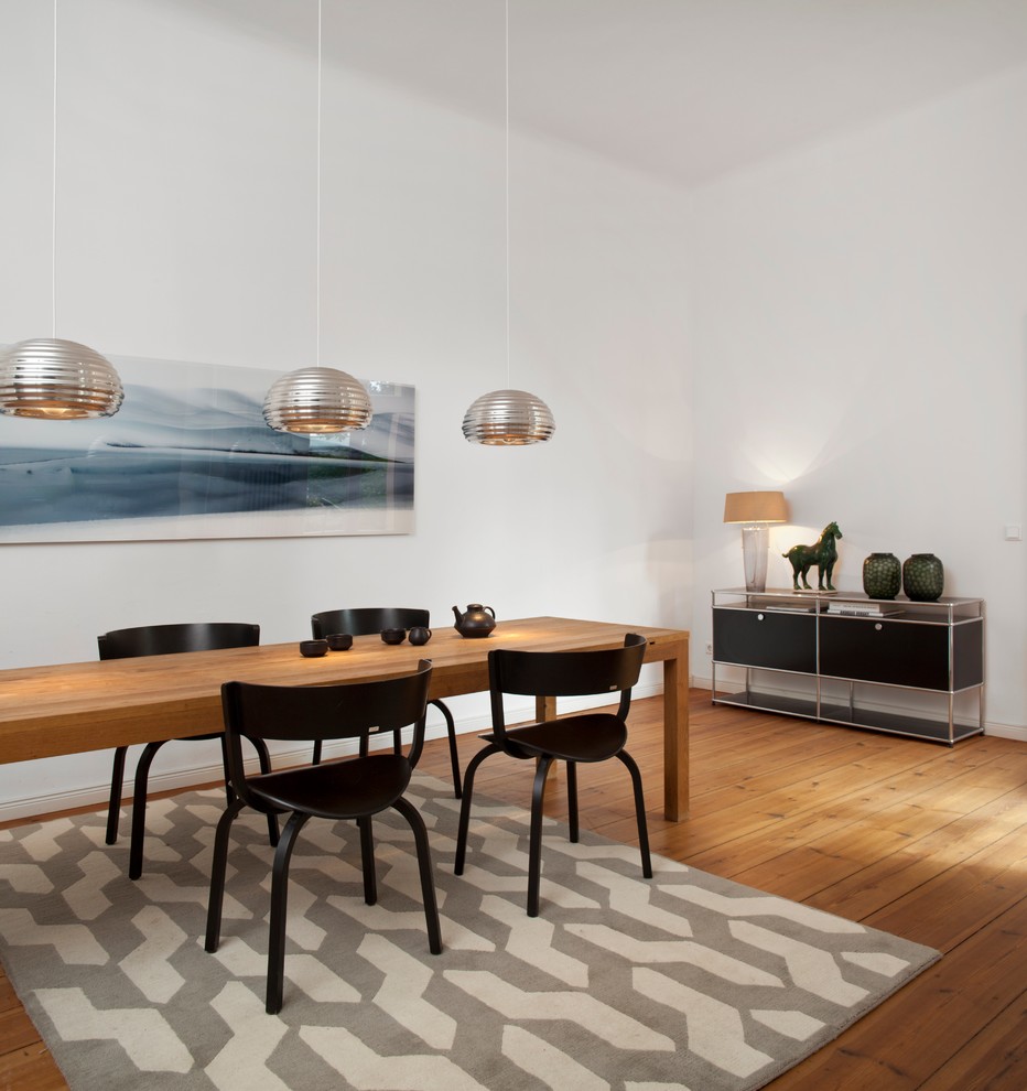 Foto di una sala da pranzo contemporanea di medie dimensioni con pareti bianche, pavimento in legno massello medio e nessun camino