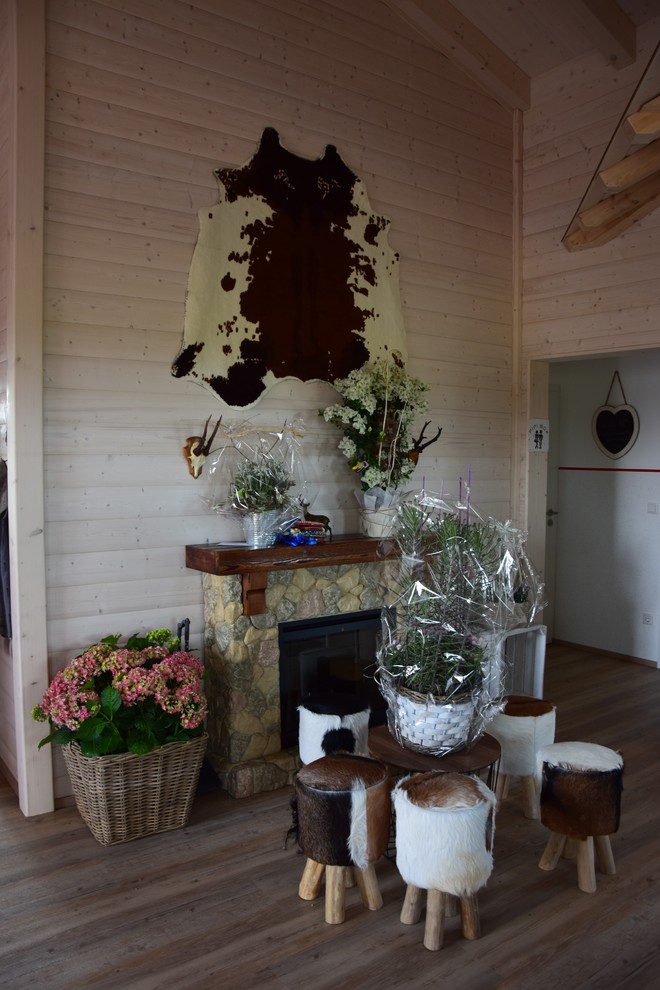 Foto di una sala da pranzo aperta verso il soggiorno rustica di medie dimensioni con pareti beige, pavimento in legno massello medio e pavimento marrone