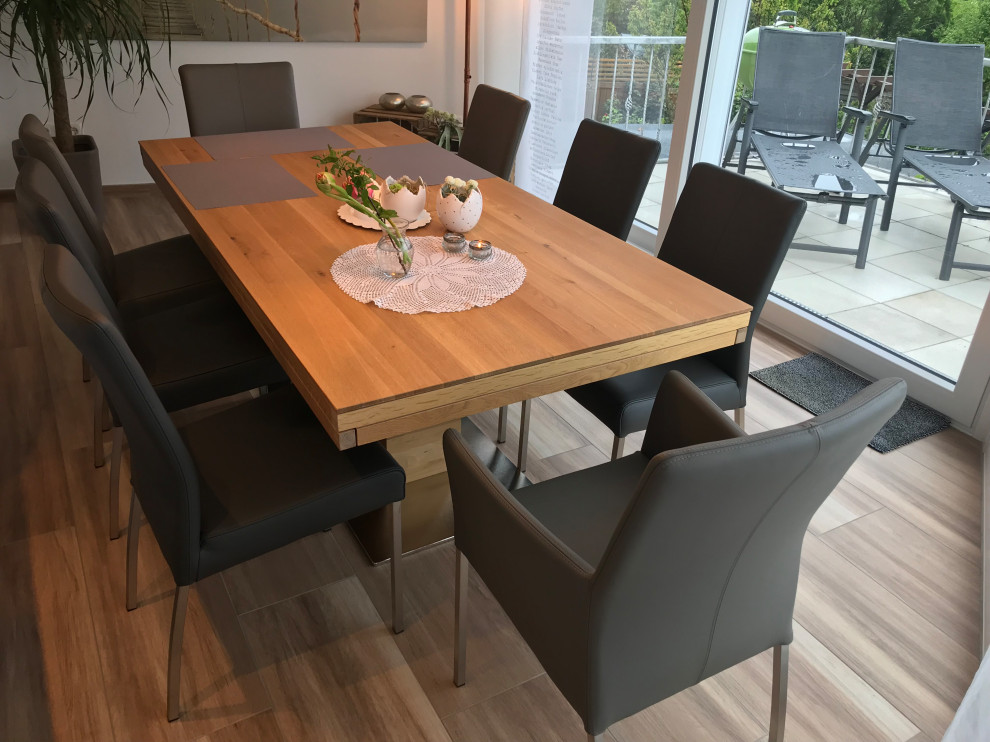 Medium sized scandi open plan dining room in Dortmund with white walls, ceramic flooring and brown floors.