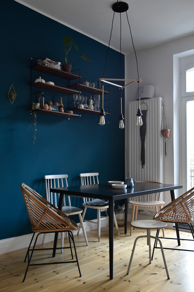 Photo of a medium sized scandi dining room in Cologne with blue walls, light hardwood flooring and beige floors.