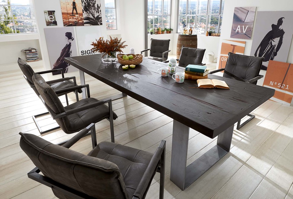 Design ideas for an urban dining room in Other with light hardwood flooring.