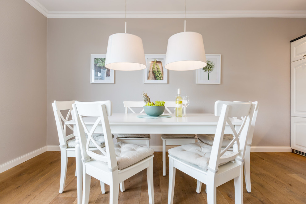 This is an example of a medium sized scandi dining room in Other with beige walls and medium hardwood flooring.