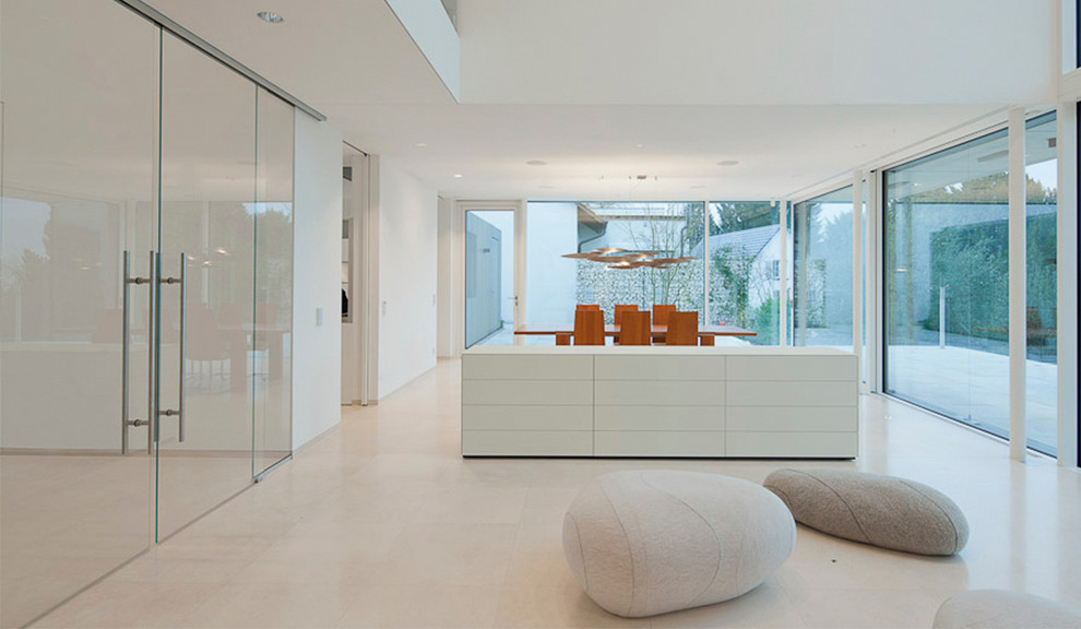 Ispirazione per una grande sala da pranzo aperta verso il soggiorno minimalista con pareti bianche