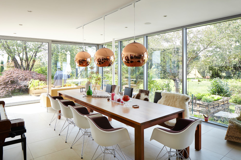 This is an example of a medium sized contemporary enclosed dining room in Dusseldorf with no fireplace and beige floors.