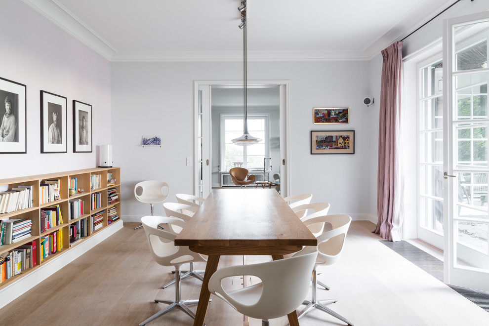 Immagine di una sala da pranzo aperta verso il soggiorno minimal di medie dimensioni con parquet chiaro, nessun camino, pavimento beige e pareti grigie