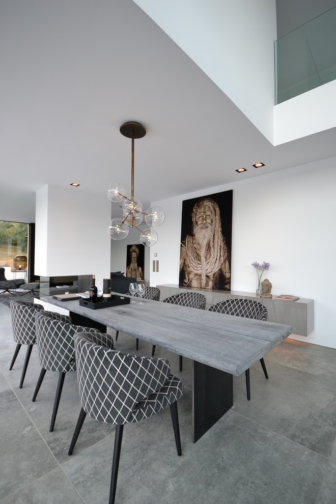 Design ideas for an expansive contemporary open plan dining room in Cologne with white walls, grey floors and no fireplace.