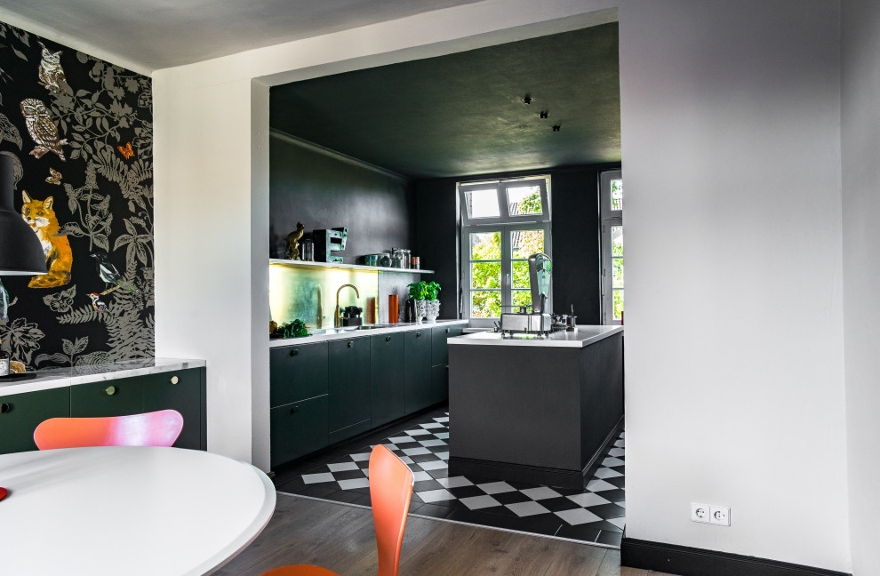 Small industrial kitchen/dining room in Bremen with black walls and light hardwood flooring.