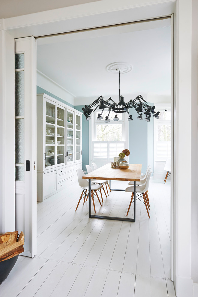 На фото: гостиная-столовая среднего размера в стиле кантри с синими стенами, деревянным полом и белым полом с