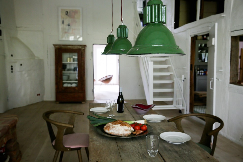 Idée de décoration pour une salle à manger urbaine de taille moyenne avec un mur blanc et un sol en bois brun.