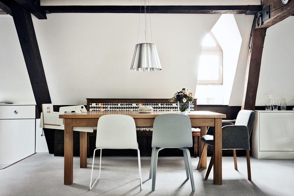 This is an example of a country open plan dining room in Hamburg with white walls.