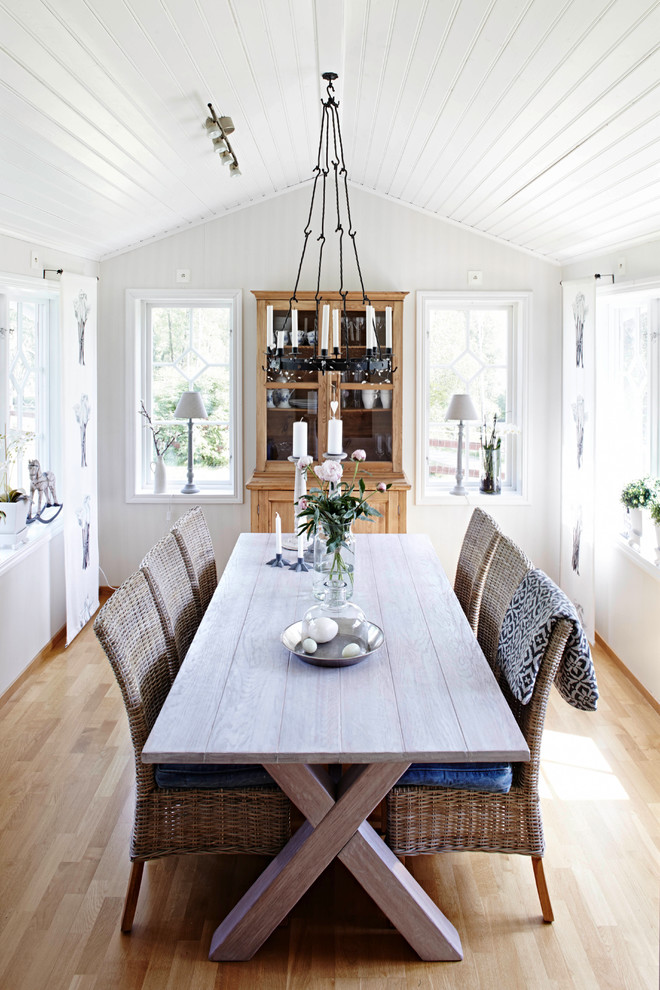 Photo of a medium sized farmhouse dining room in Bremen with white walls, light hardwood flooring and no fireplace.