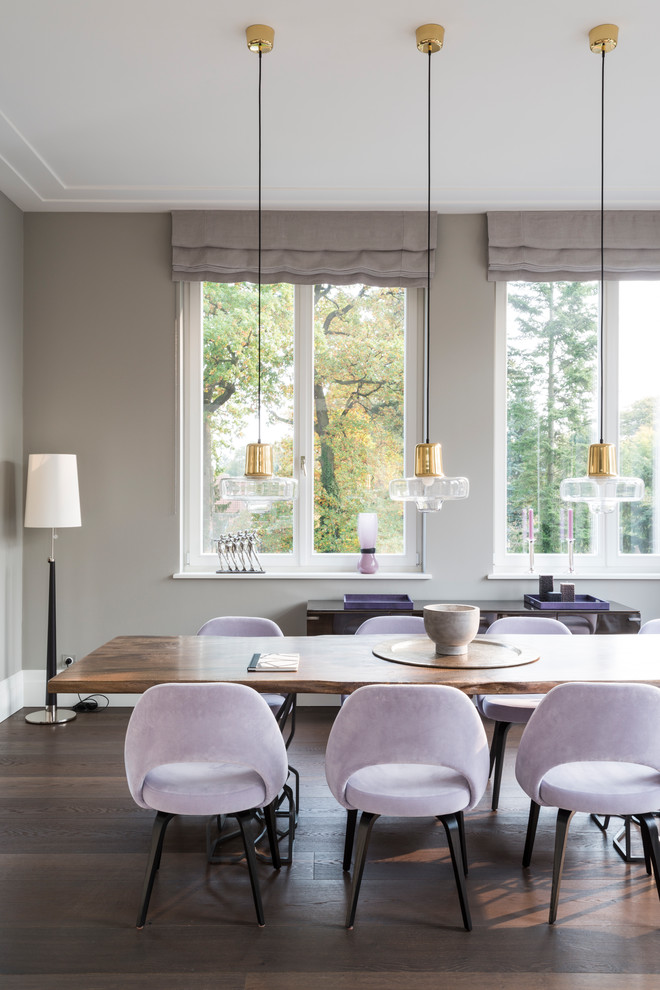 Photo of a medium sized contemporary open plan dining room in Hamburg with grey walls, dark hardwood flooring and brown floors.