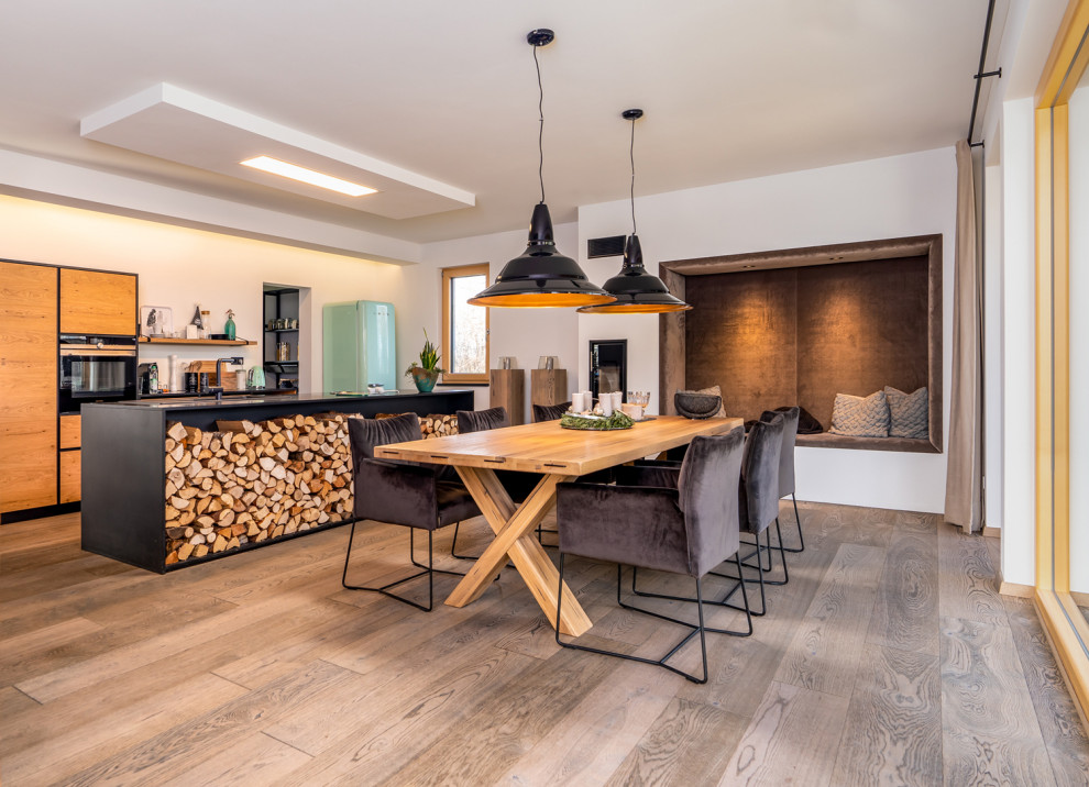 Exemple d'une grande salle à manger ouverte sur le salon craftsman avec un mur blanc, un sol en bois brun et un sol gris.