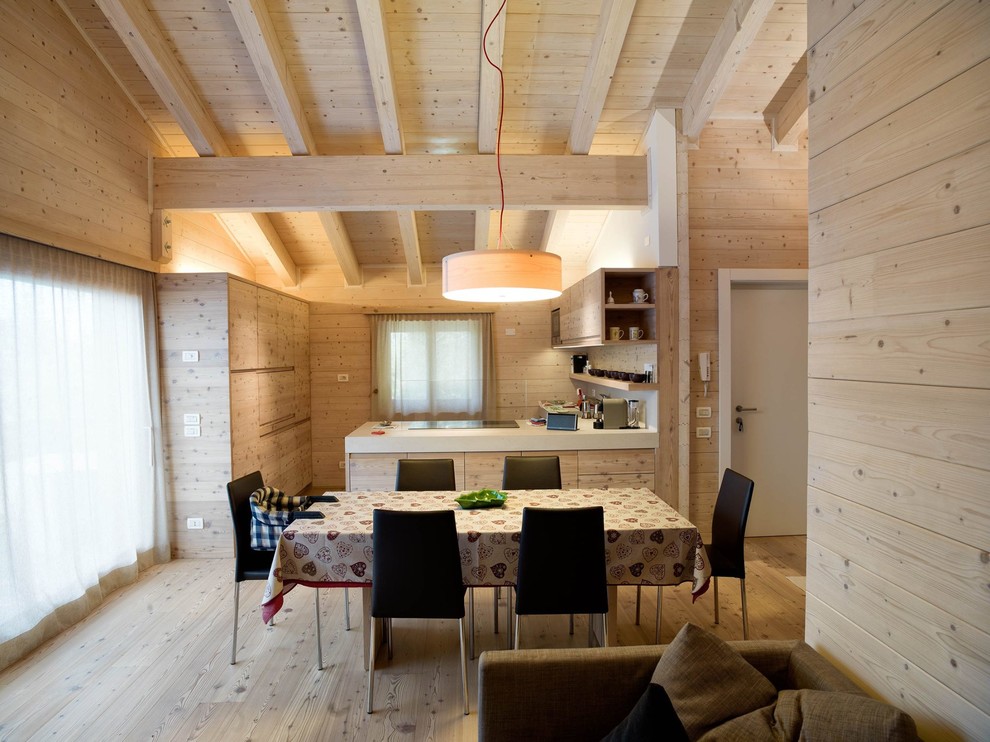 Example of a mid-sized farmhouse light wood floor and brown floor kitchen/dining room combo design in Munich with brown walls