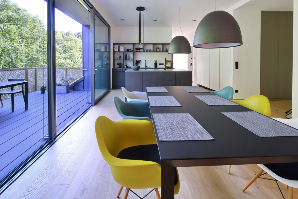 Идея дизайна: большая кухня-столовая в современном стиле с белыми стенами и светлым паркетным полом