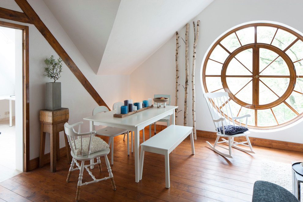 Design ideas for a scandinavian dining room in Frankfurt with white walls and medium hardwood flooring.