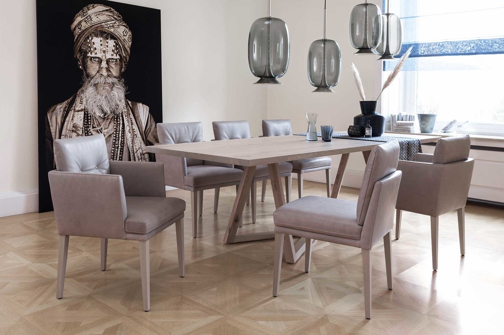 Enclosed dining room - mid-sized contemporary light wood floor and beige floor enclosed dining room idea in Munich with white walls and no fireplace