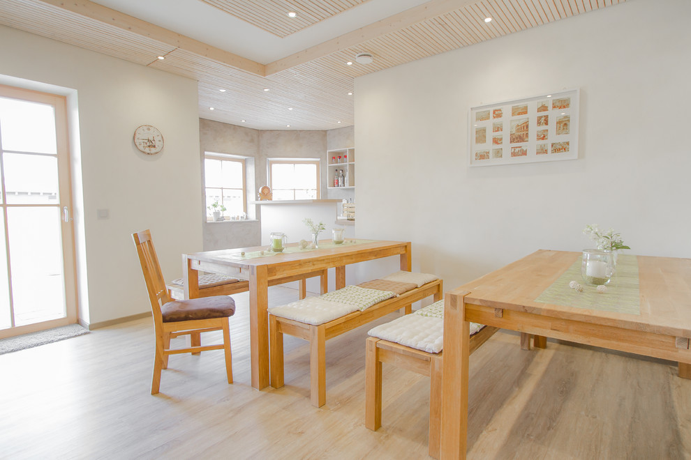 Cette photo montre une salle à manger ouverte sur le salon scandinave de taille moyenne avec un mur blanc, parquet clair, aucune cheminée et un sol beige.