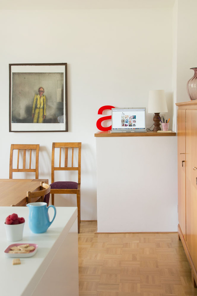 Dining room - mid-sized scandinavian medium tone wood floor dining room idea in Other with white walls