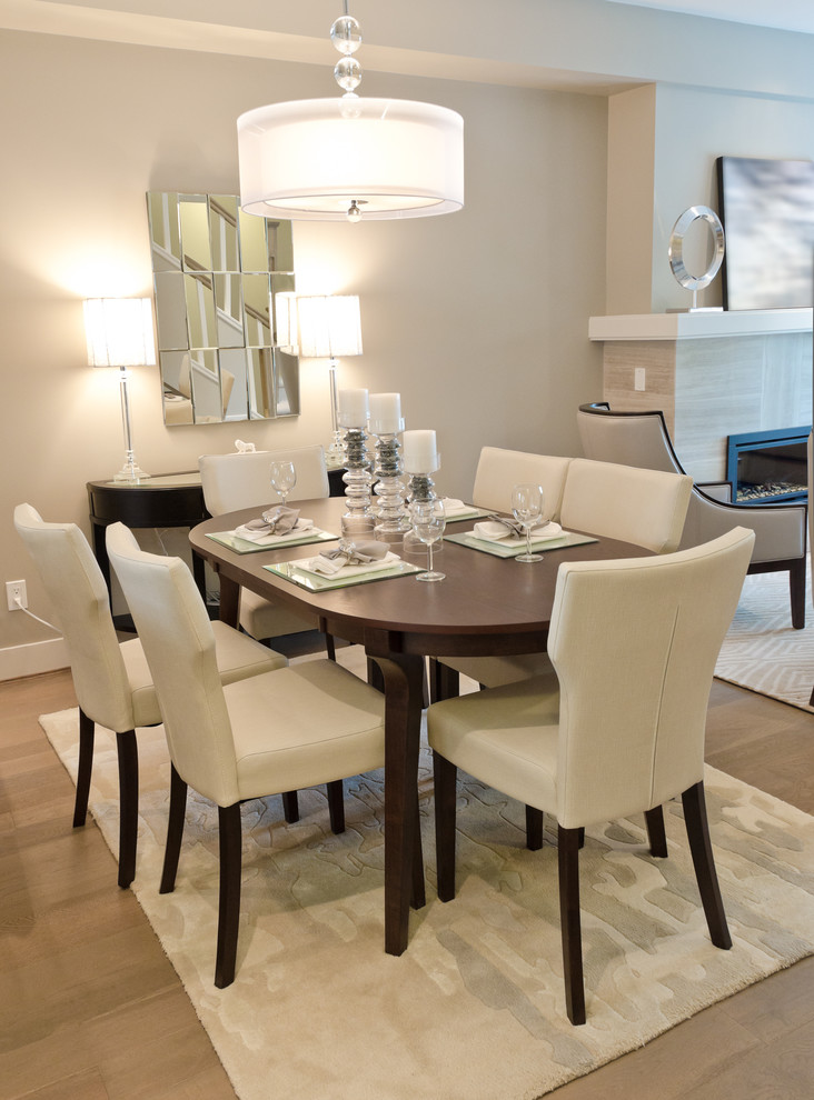 This is an example of a medium sized classic open plan dining room in Other with grey walls, medium hardwood flooring and a tiled fireplace surround.