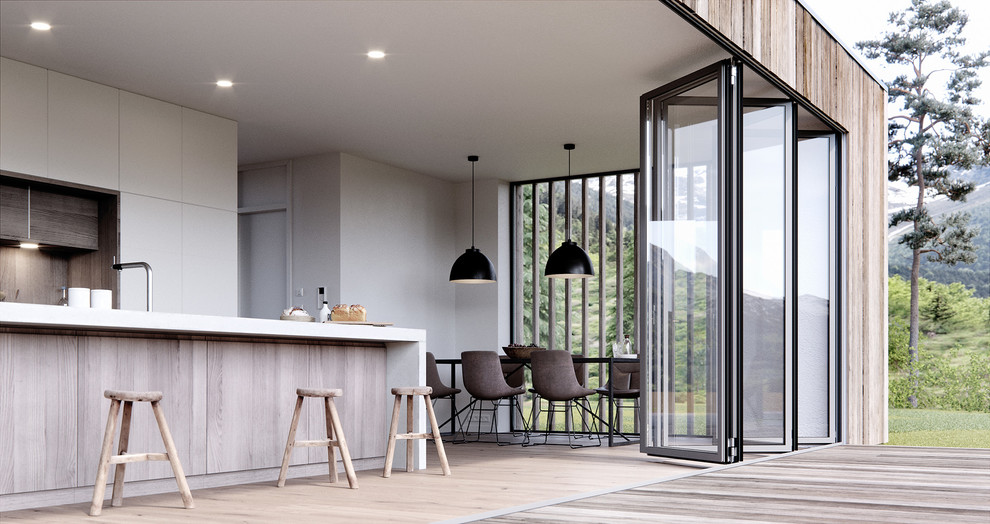 Moderne Wohnküche mit grauer Wandfarbe, hellem Holzboden und beigem Boden in Bremen
