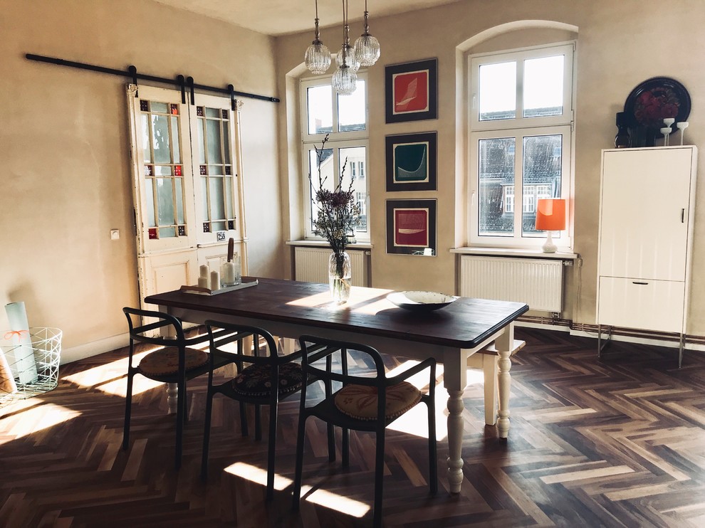 Large eclectic medium tone wood floor and brown floor enclosed dining room photo in Berlin with brown walls and no fireplace