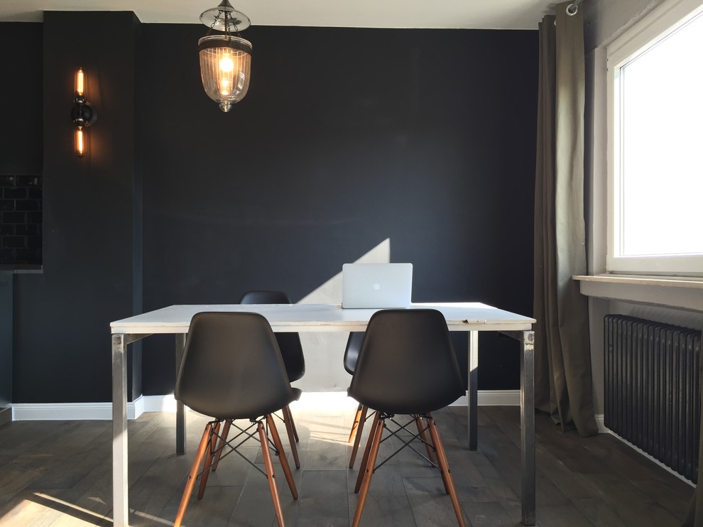 Inspiration for an industrial dining room in Berlin with black walls.