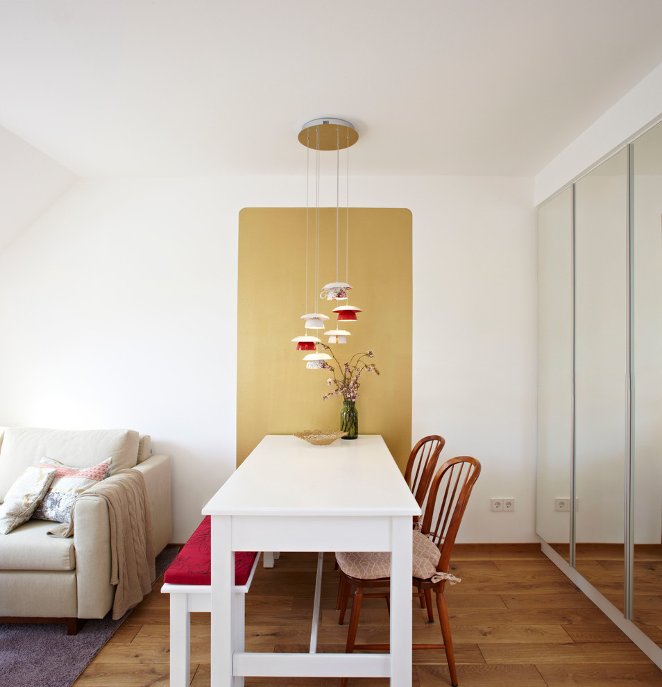 Photo of a small contemporary dining room in Munich with white walls.