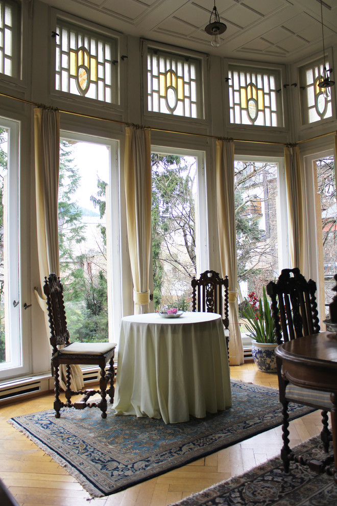 Photo of a traditional dining room in Other with medium hardwood flooring.