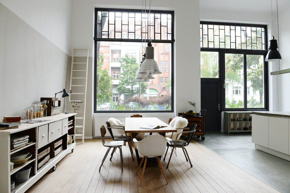 Design ideas for a large scandi dining room in Berlin with white walls and medium hardwood flooring.