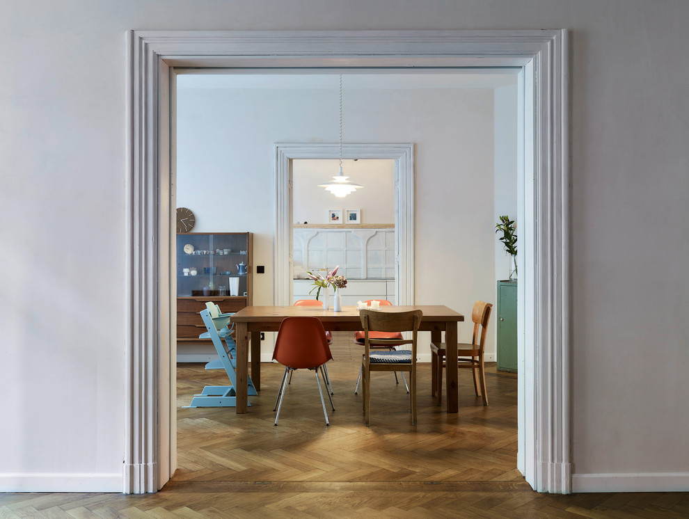 Design ideas for a medium sized retro open plan dining room in Leipzig with white walls, medium hardwood flooring, no fireplace and brown floors.
