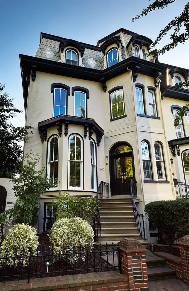 Design ideas for a beige victorian house exterior in DC Metro with three floors.