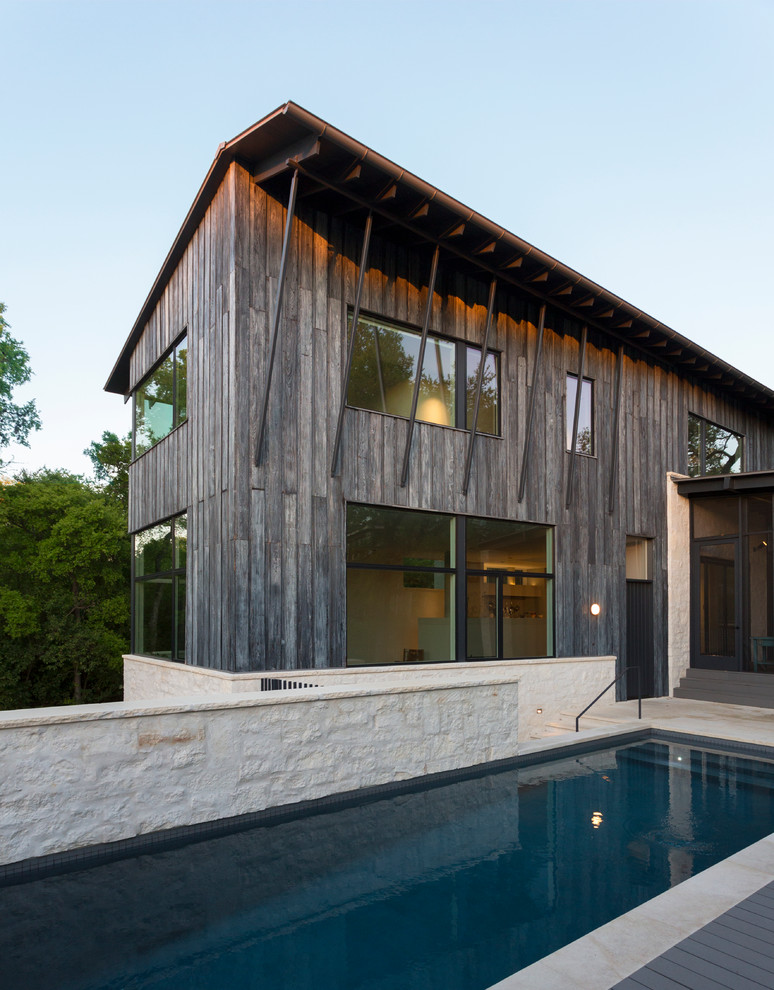 Example of a mid-sized minimalist gray two-story wood gable roof design in Austin