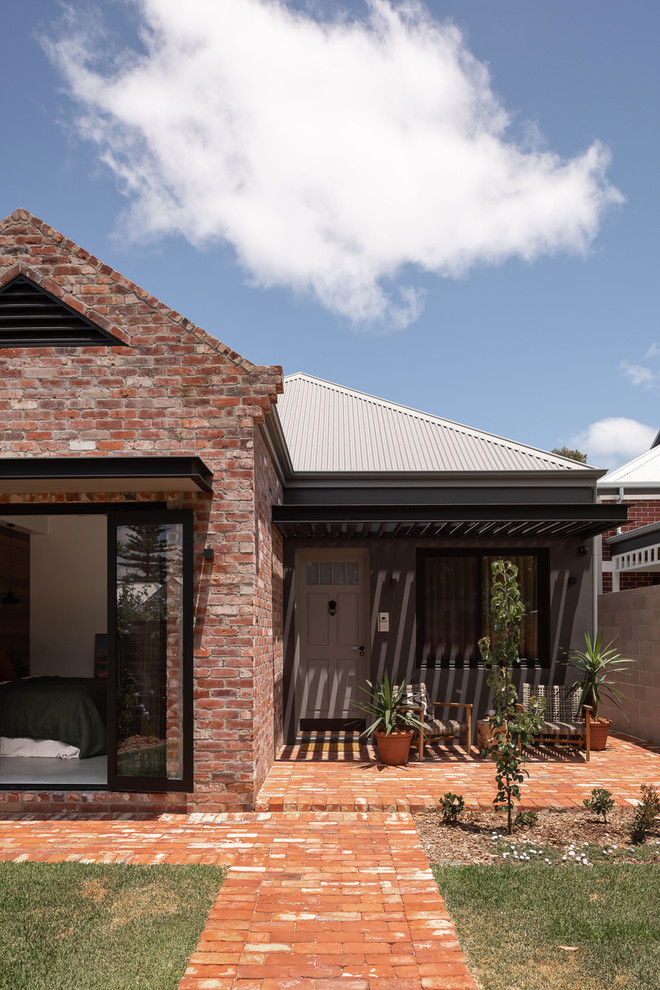 Example of an urban multicolored two-story brick exterior home design in Perth with a metal roof