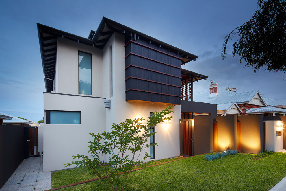 На фото: большой, двухэтажный, кирпичный, серый дом в современном стиле с вальмовой крышей