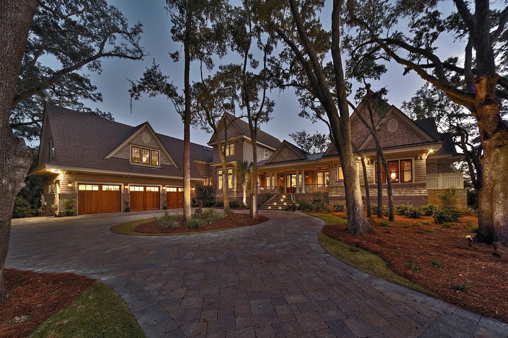 Large elegant brown two-story wood exterior home photo in Charleston with a shingle roof