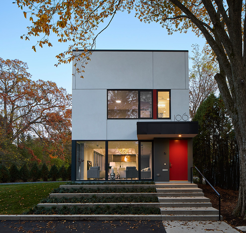 Aménagement d'une façade de maison grise contemporaine de taille moyenne et à un étage avec un revêtement mixte et un toit plat.
