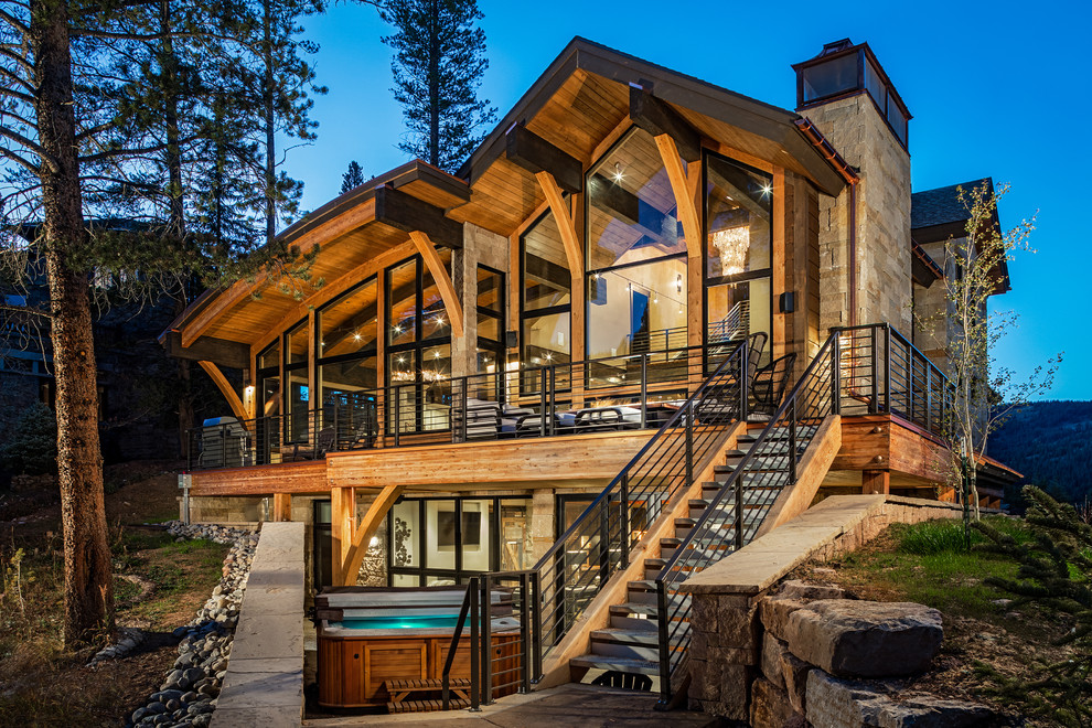 Rustic two-story glass house exterior idea in Denver
