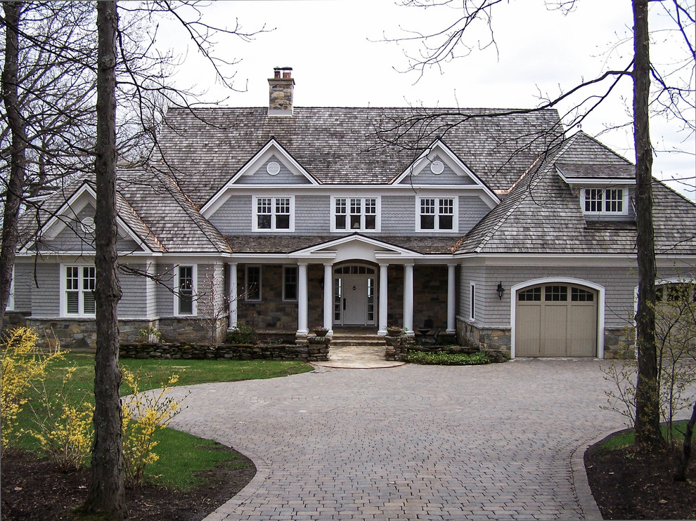 Inspiration for a large timeless gray two-story wood exterior home remodel in Montreal with a shingle roof