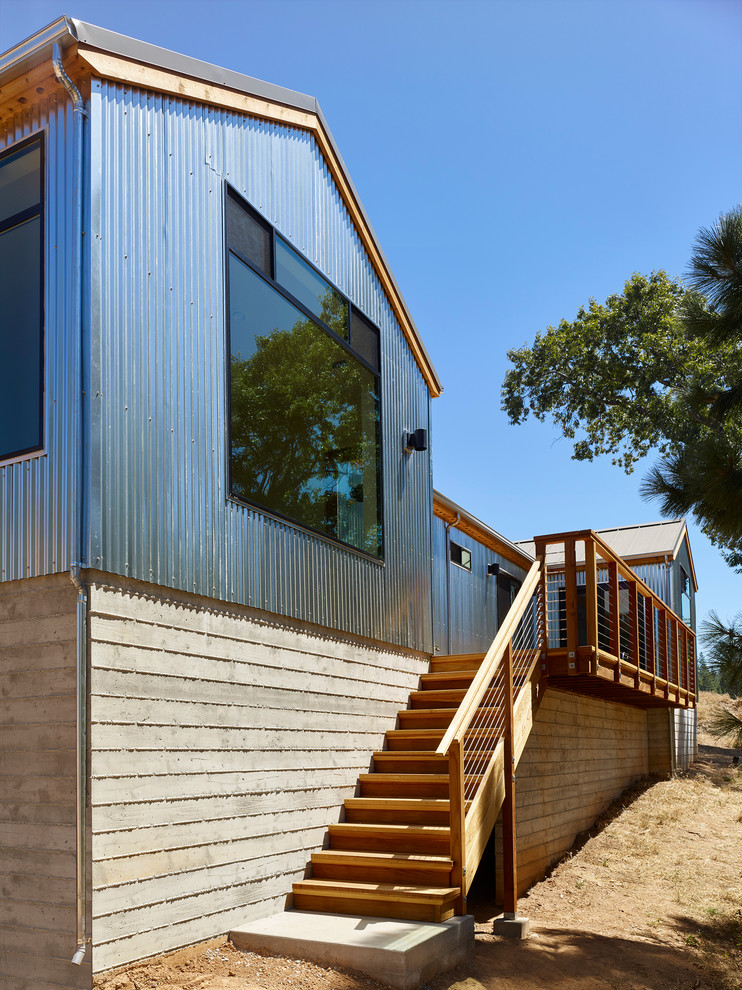 Industrial bungalow house exterior in Sacramento with metal cladding and a pitched roof.