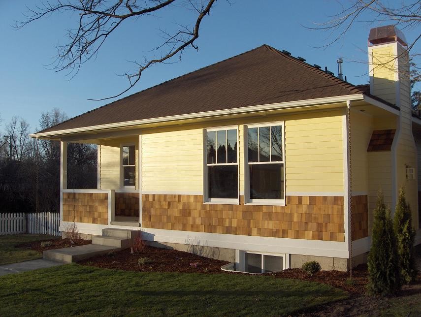 Example of a mid-sized classic yellow one-story mixed siding house exterior design in Boise with a hip roof and a shingle roof