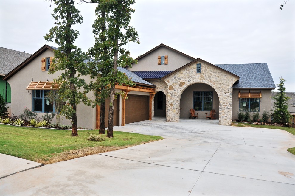 Inspiration for a large and brown rustic bungalow render house exterior in Oklahoma City.