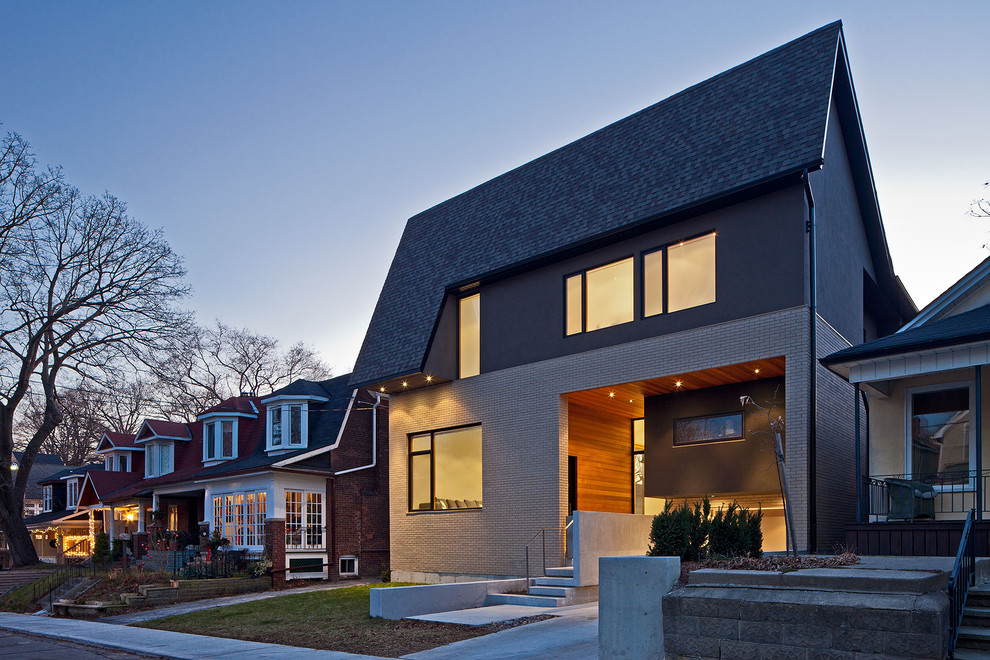 Inspiration for a contemporary house exterior in Toronto with wood cladding.