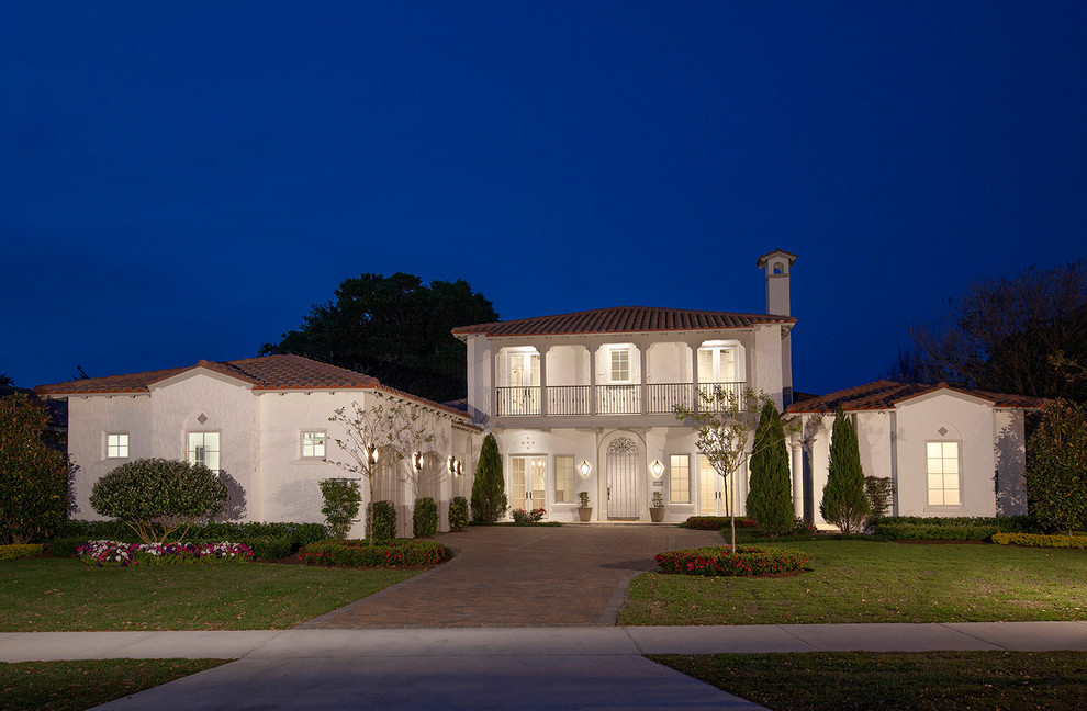 Large mediterranean white two-story stucco exterior home idea in Orlando