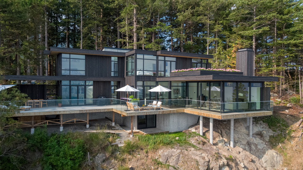 Inspiration for a contemporary gray three-story wood exterior home remodel in Vancouver