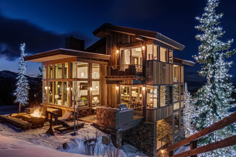 Large and brown rustic detached house in Salt Lake City with three floors and wood cladding.