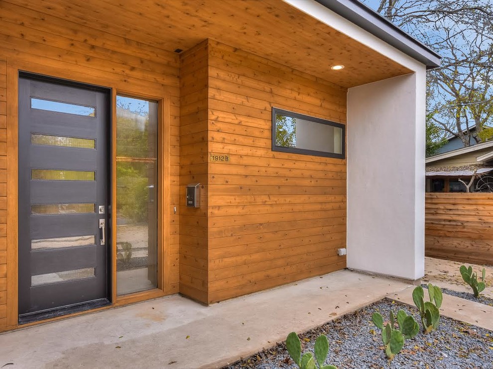 Réalisation d'une façade de maison multicolore design en bois de taille moyenne et de plain-pied avec un toit à deux pans et un toit en shingle.