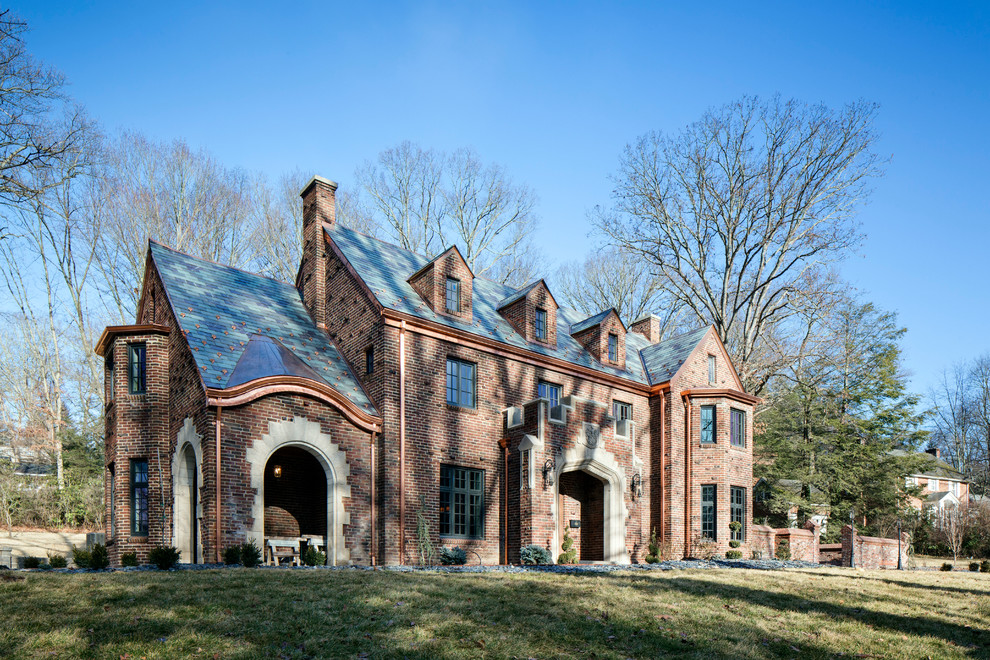 Inspiration for a timeless red three-story brick house exterior remodel in Other