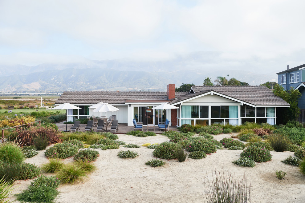 Small beach style white one-story wood exterior home photo in Santa Barbara with a shingle roof