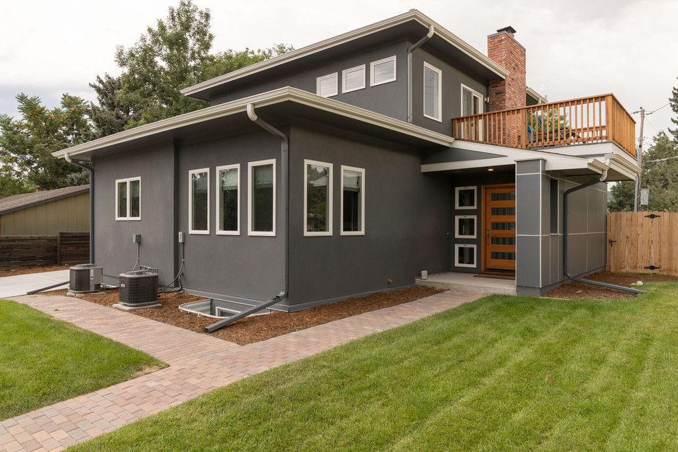 Inspiration for a mid-sized mid-century modern gray two-story concrete fiberboard gable roof remodel in Denver